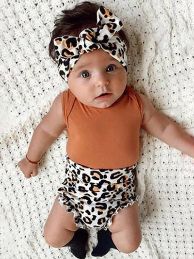 Baby set features a onesie with high waisted leopard printed bloomers and a matching headband