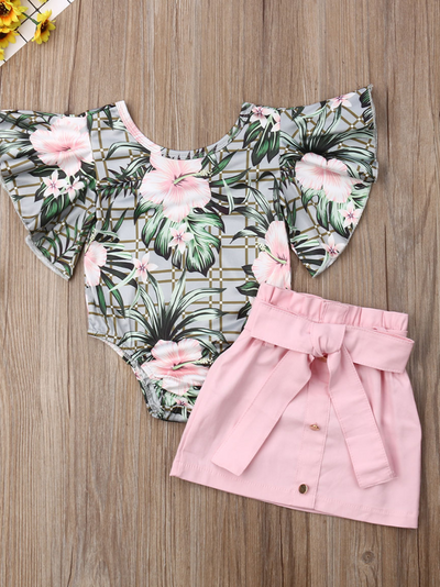 Baby set has a ruffled onesie with tropical print and pink skirt with front buttons and sash