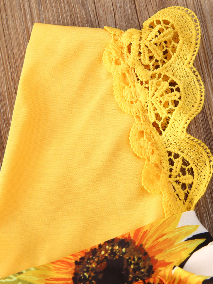 Baby yellow romper onesie with a skirt overlay with sunflower print and matching headband