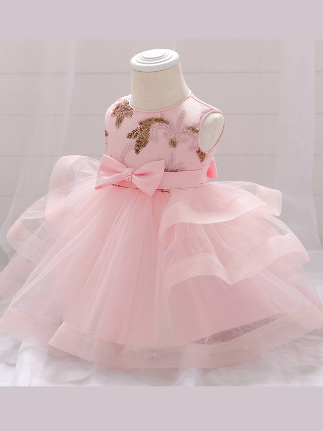 Baby princess dress has a satin bodice with sequin applique, a bow belt at the waist, and a layered tulle skirt