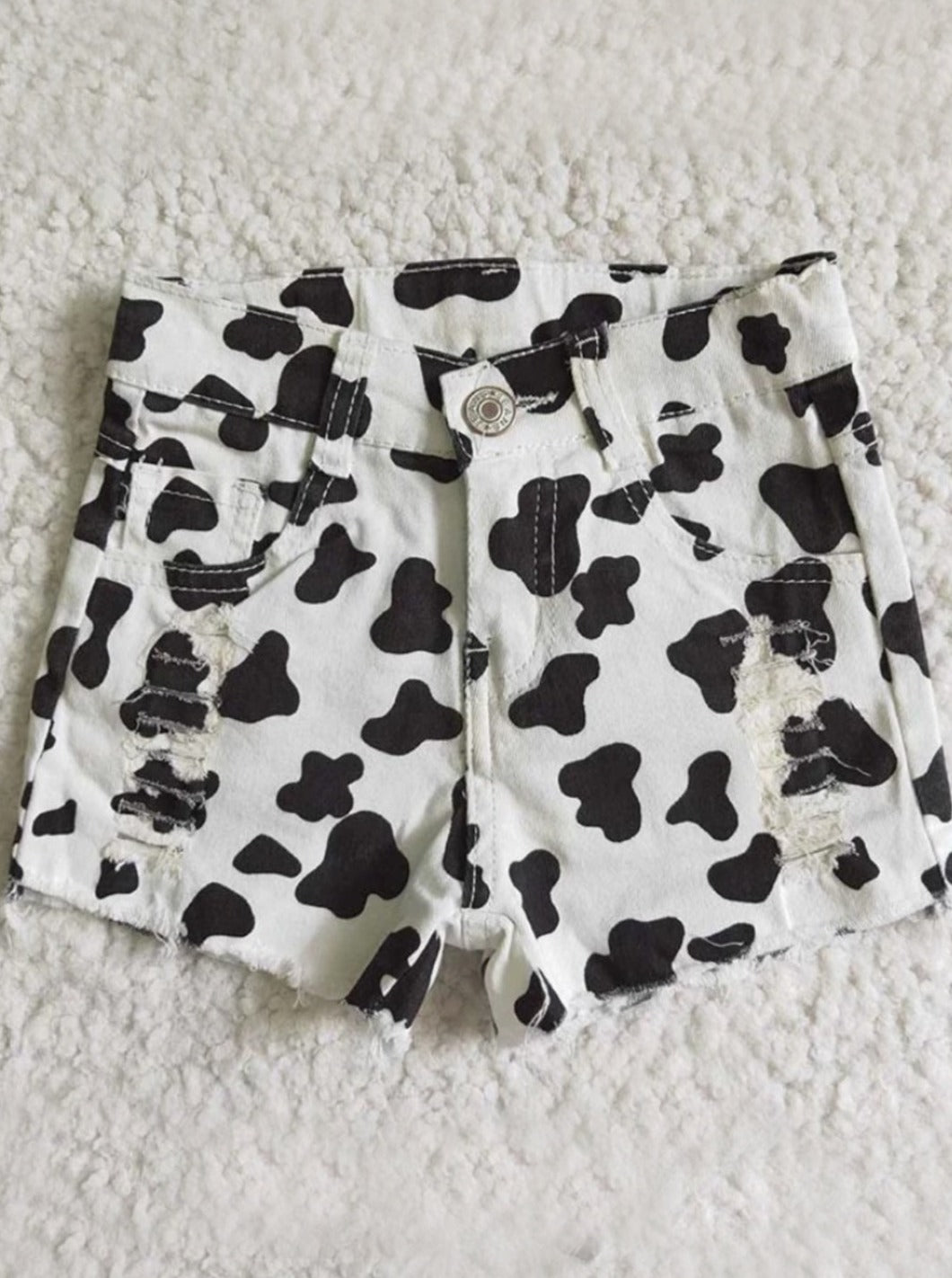 Wild Child Cow Print Distressed Shorts