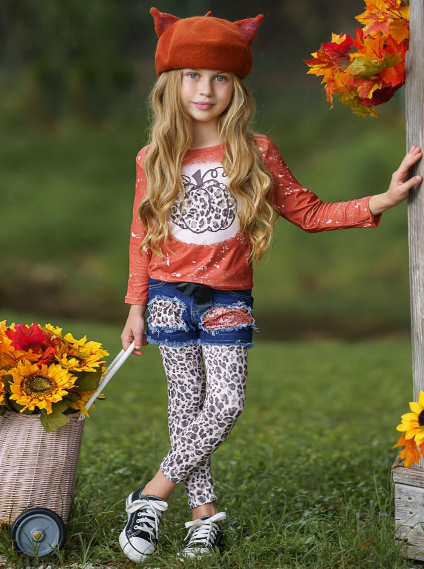 Girls Set features a top with leopard pumpkin print and patched denim shorts with black sash and leopard leggings