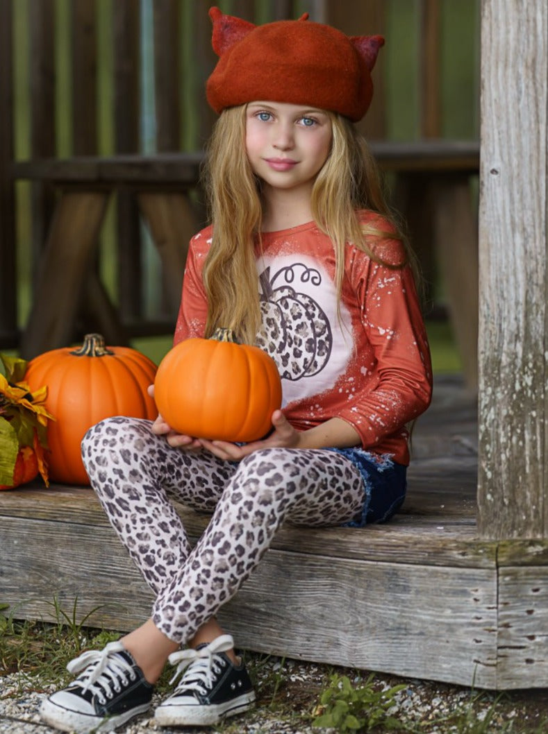 Girls Set features a top with leopard pumpkin print and patched denim shorts with black sash and leopard leggings