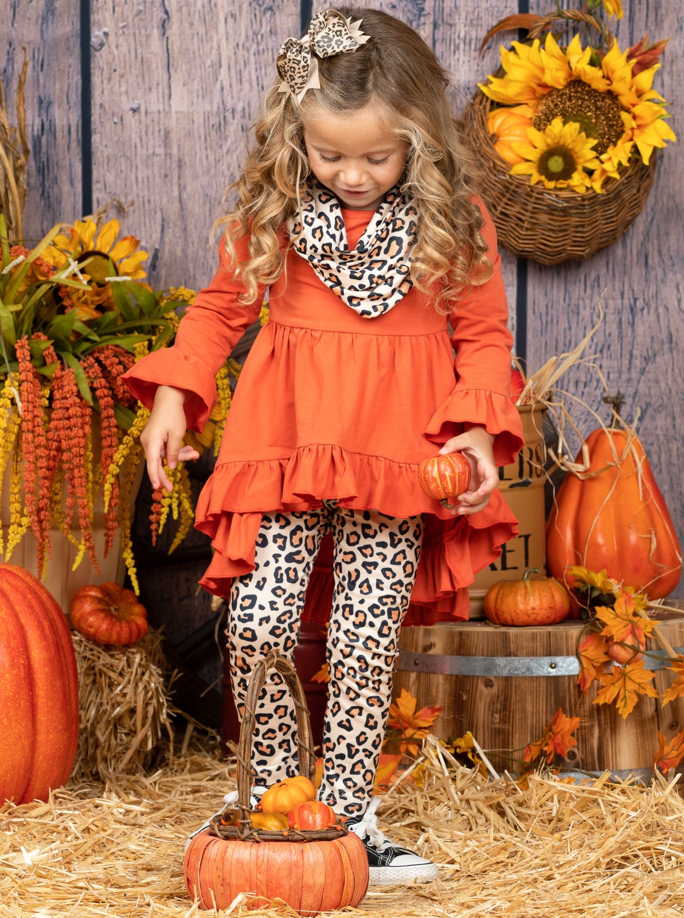 Girls Set features a hi-lo ruffled tunic with leopard print leggings and a matching scarf