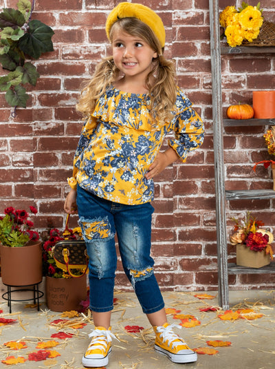 Girls set features a double ruffle neckline bib, floral top, and patched jeans.