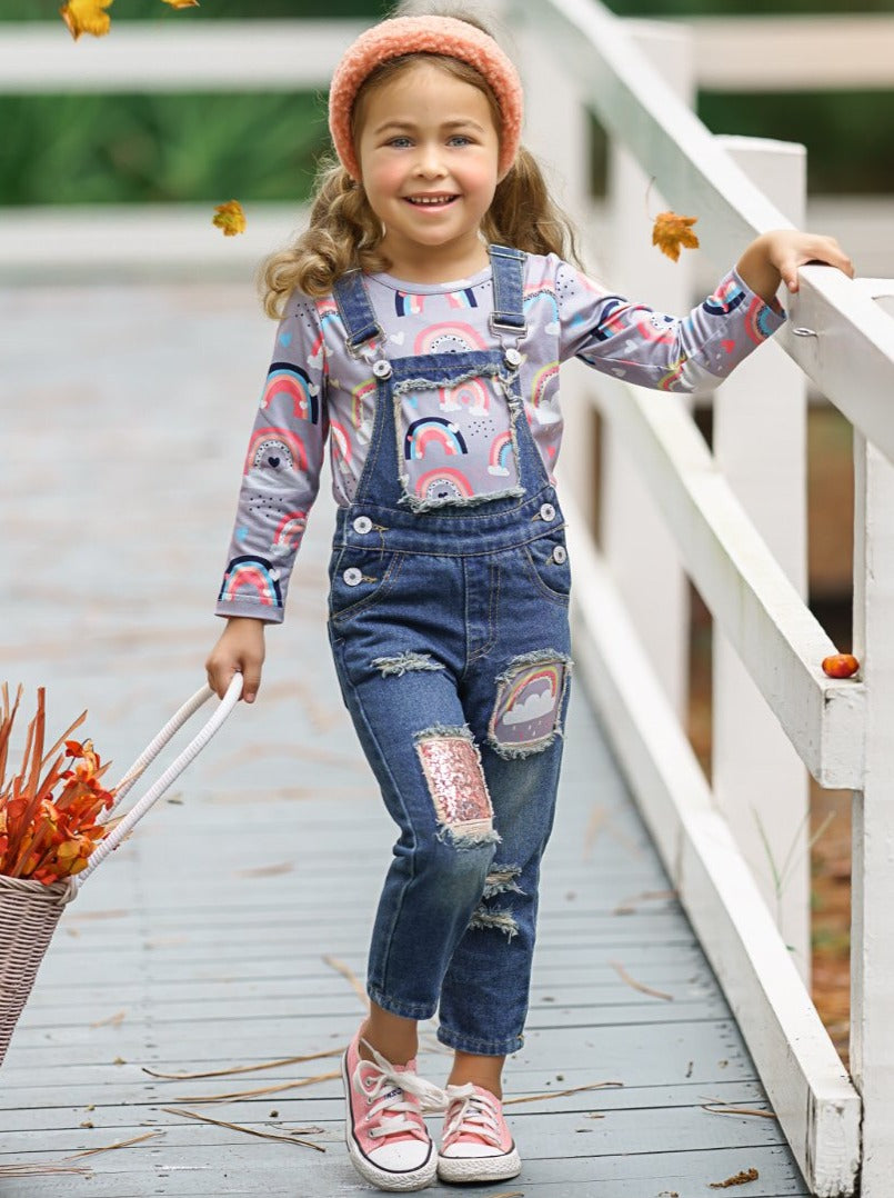 Girls Set features long sleeved rainbow top and patched denim overalls with adjustable shoulder straps