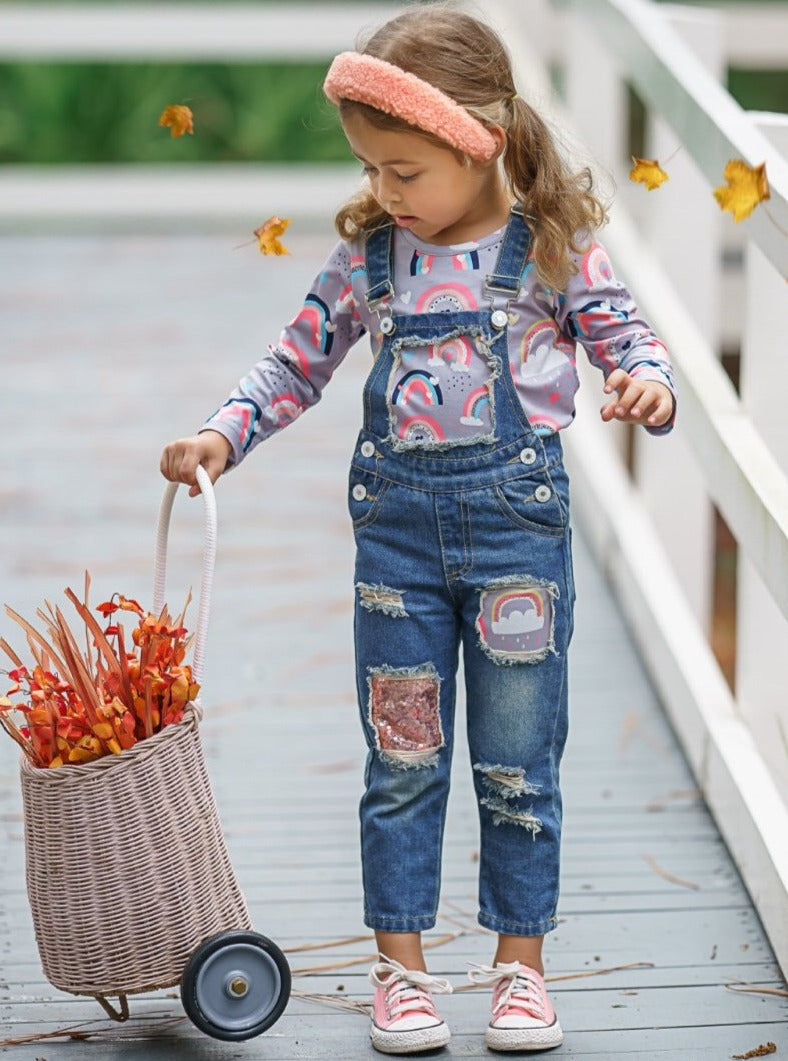 Girls Set features long sleeved rainbow top and patched denim overalls with adjustable shoulder straps