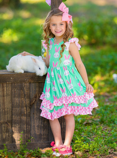 Girls Easter dress features a bunny print two-tiered design with Gingham flutter sleeves and hem