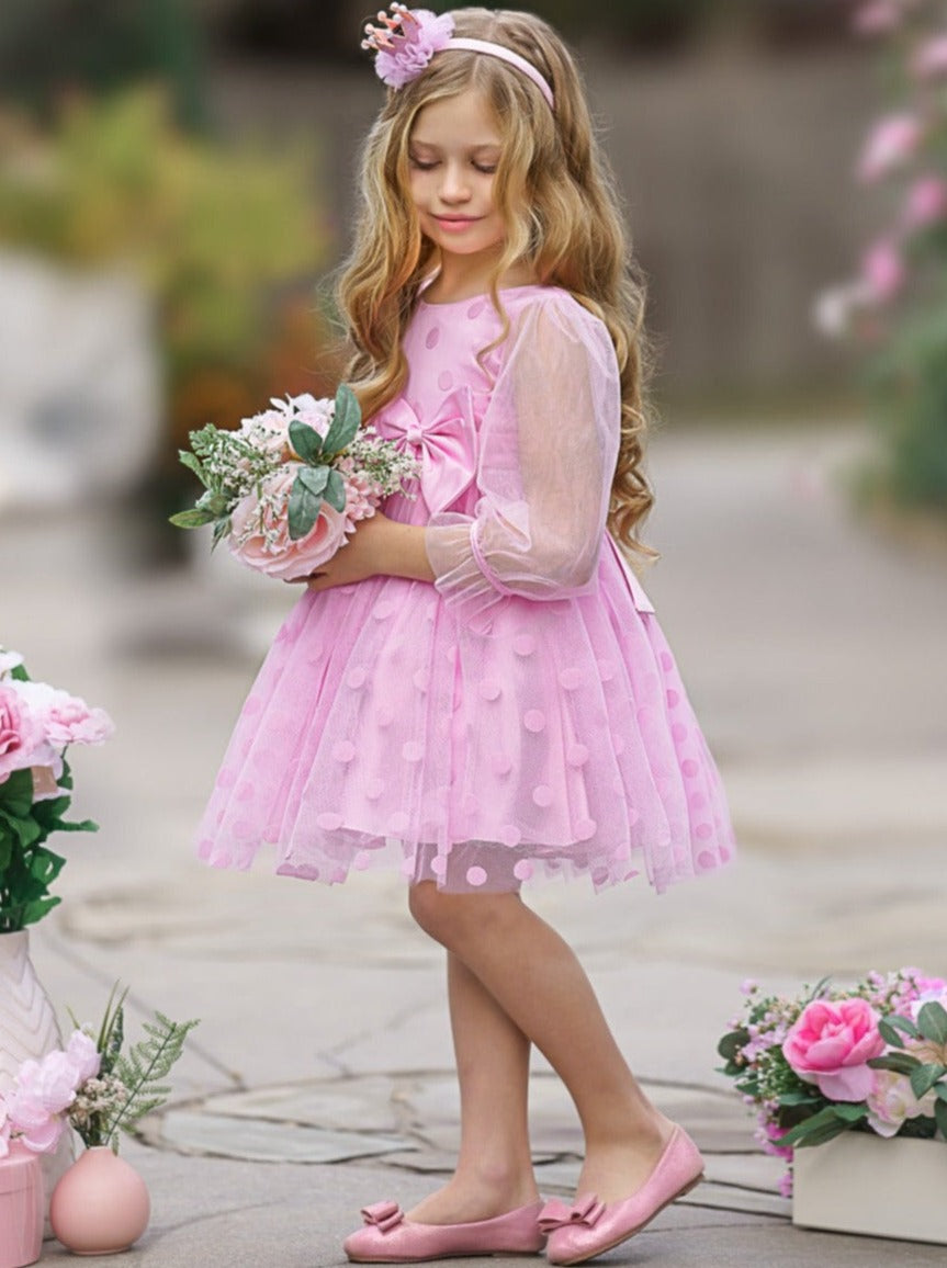 Girls tutu dress features polka dot swiss tulle with long sheer sleeves and bow waistline