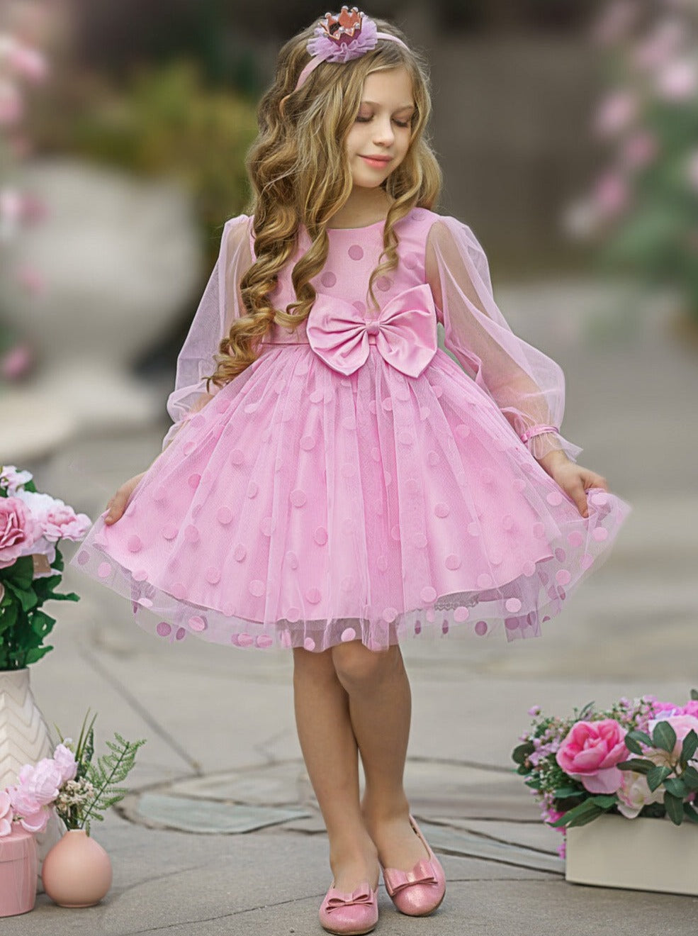 Girls tutu dress features polka dot swiss tulle with long sheer sleeves and bow waistline