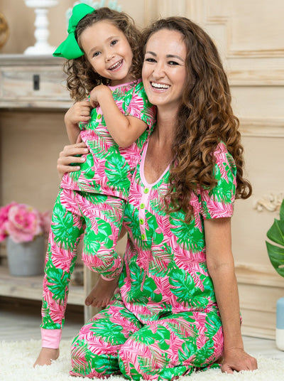 Mommy and Me short leeved pink pajamas feature pink/green palm leaf prints, 3 front buttons, and pink cuffs on the kid version 
