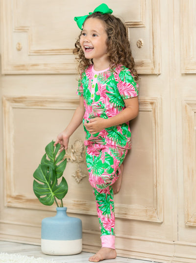 short leeved pink pajamas feature pink/green palm leaf prints, 3 front buttons, and pink cuffs on the kid version