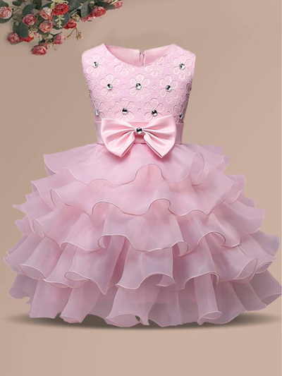 Baby princess dress has a floral lace bodice with rhinestone details, a bow belt at the waist, and a multi-layered tulle skirt-pink