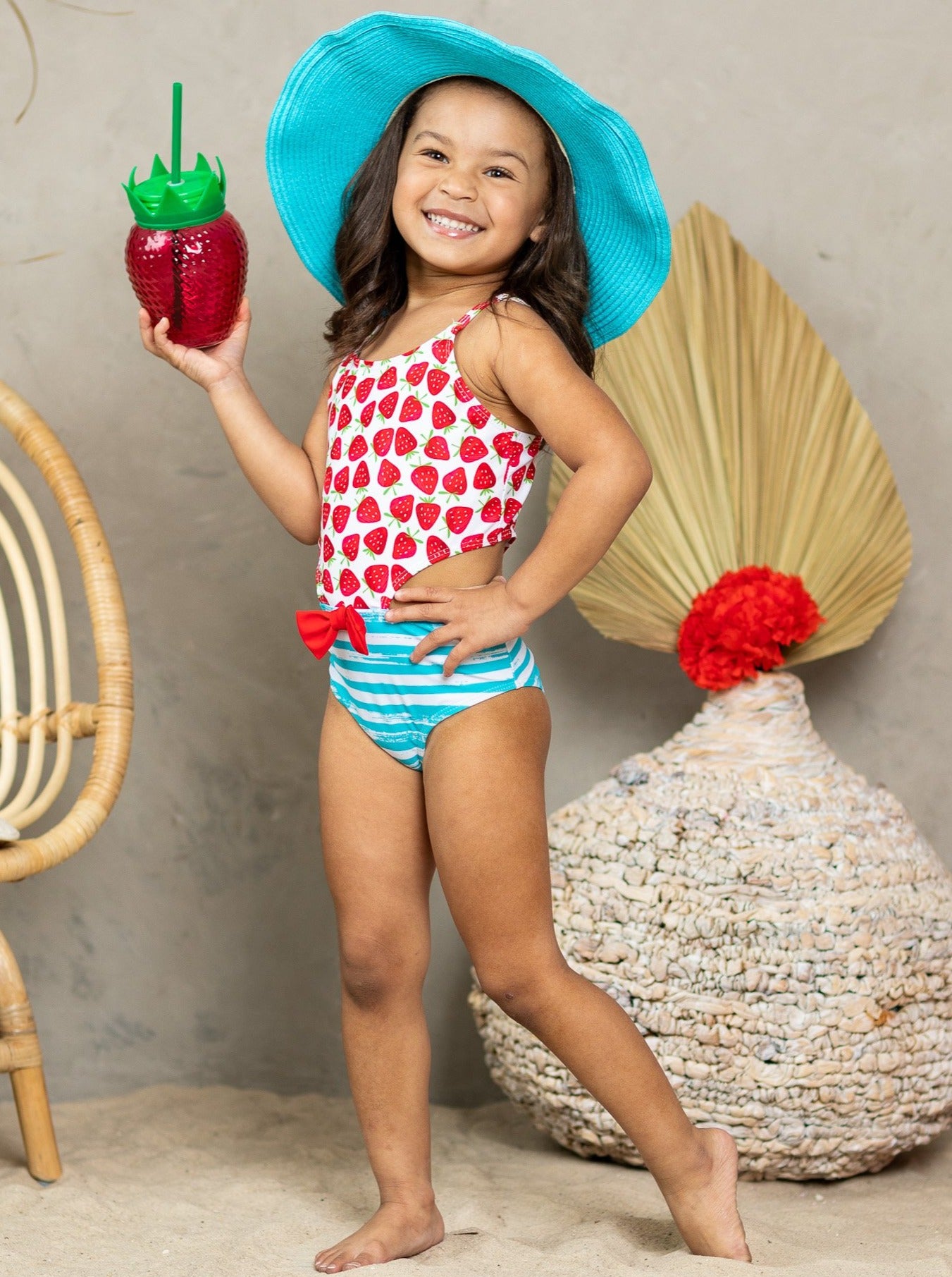 One-piece open-side swimsuit with strawberry print top and striped print bottoms and a red bow - Girls One-Piece Swimsuit