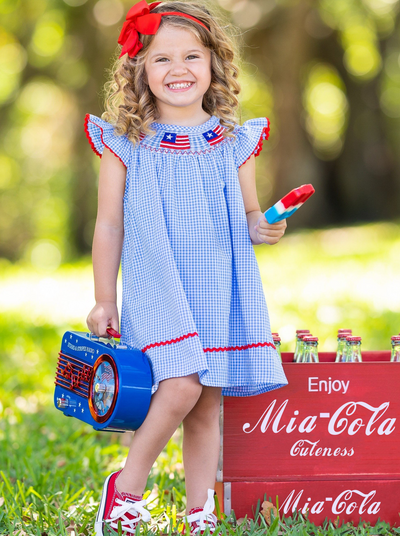 Girls dress features little flag appliques at the neckline with a red strip at the hem and flutter sleeve trim 2T-10Y for toddlers and girls 