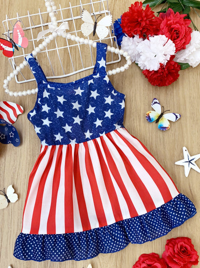 girls dress features a blue bodice with white stars, a red/white striped skirt, and a starred hem