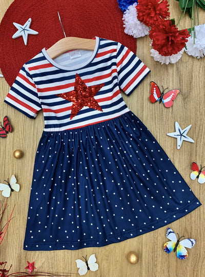 Girls dress features a red/white/blue striped bodice and a red sequin star and blue/white starred  skirt