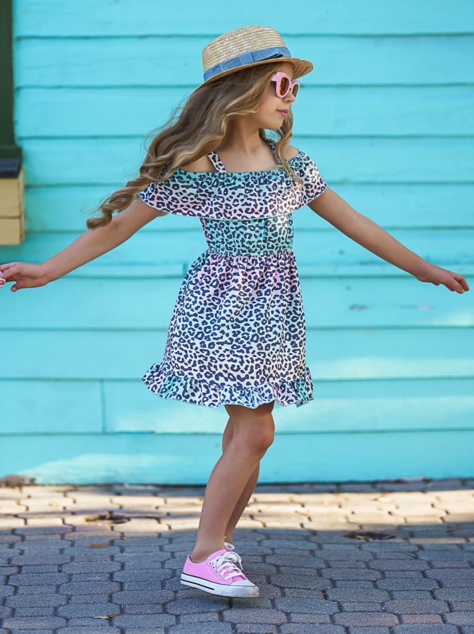 Girls dress features a cold-shoulder 360-degree ruffle bib, cinched waist, ruffle hem, and pastel ombre leopard print pattern