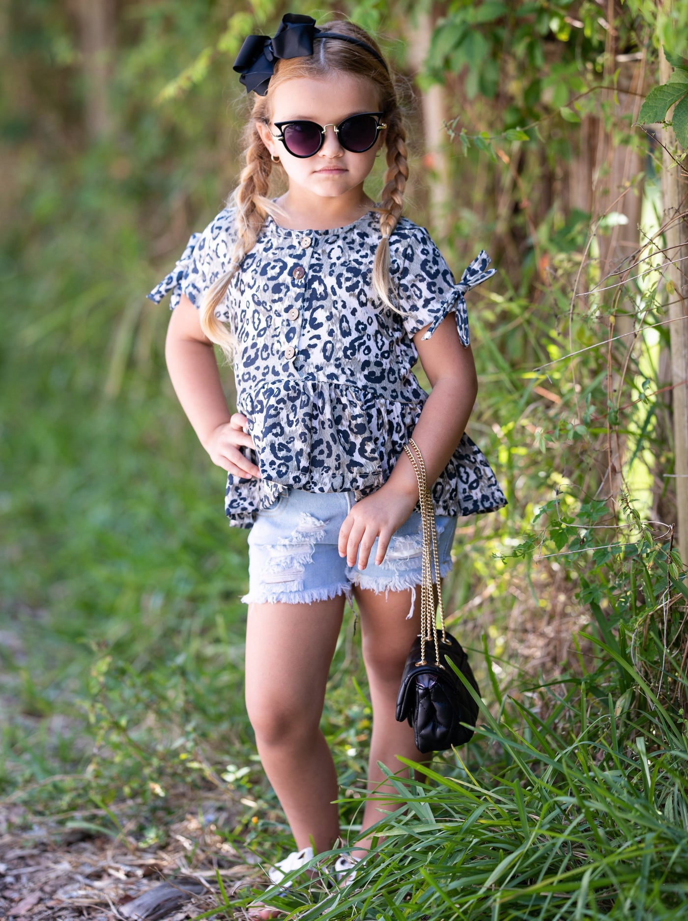 girls set features a leopard printed top with distressed denim shorts