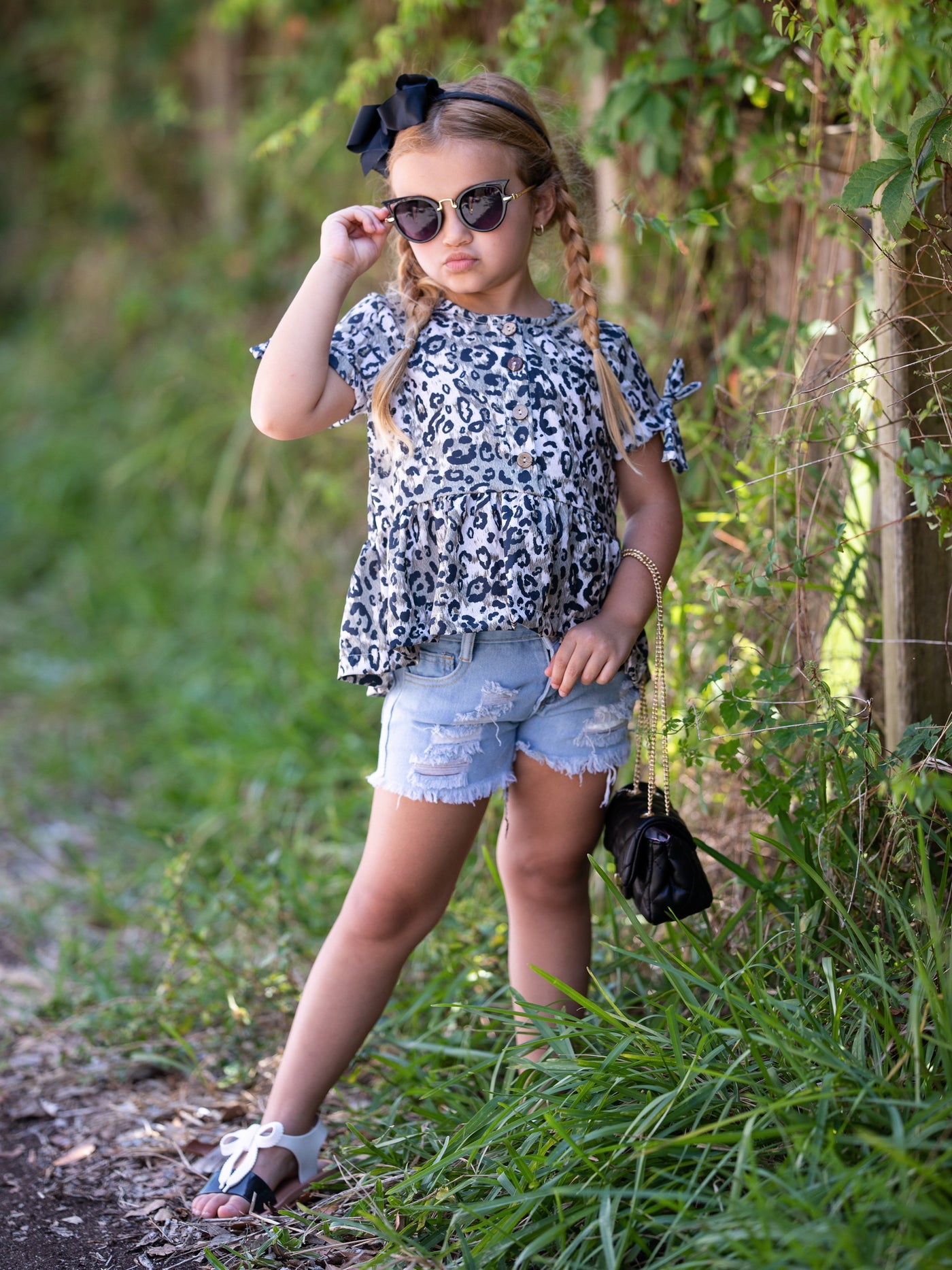 girls set features a leopard printed top with distressed denim shorts