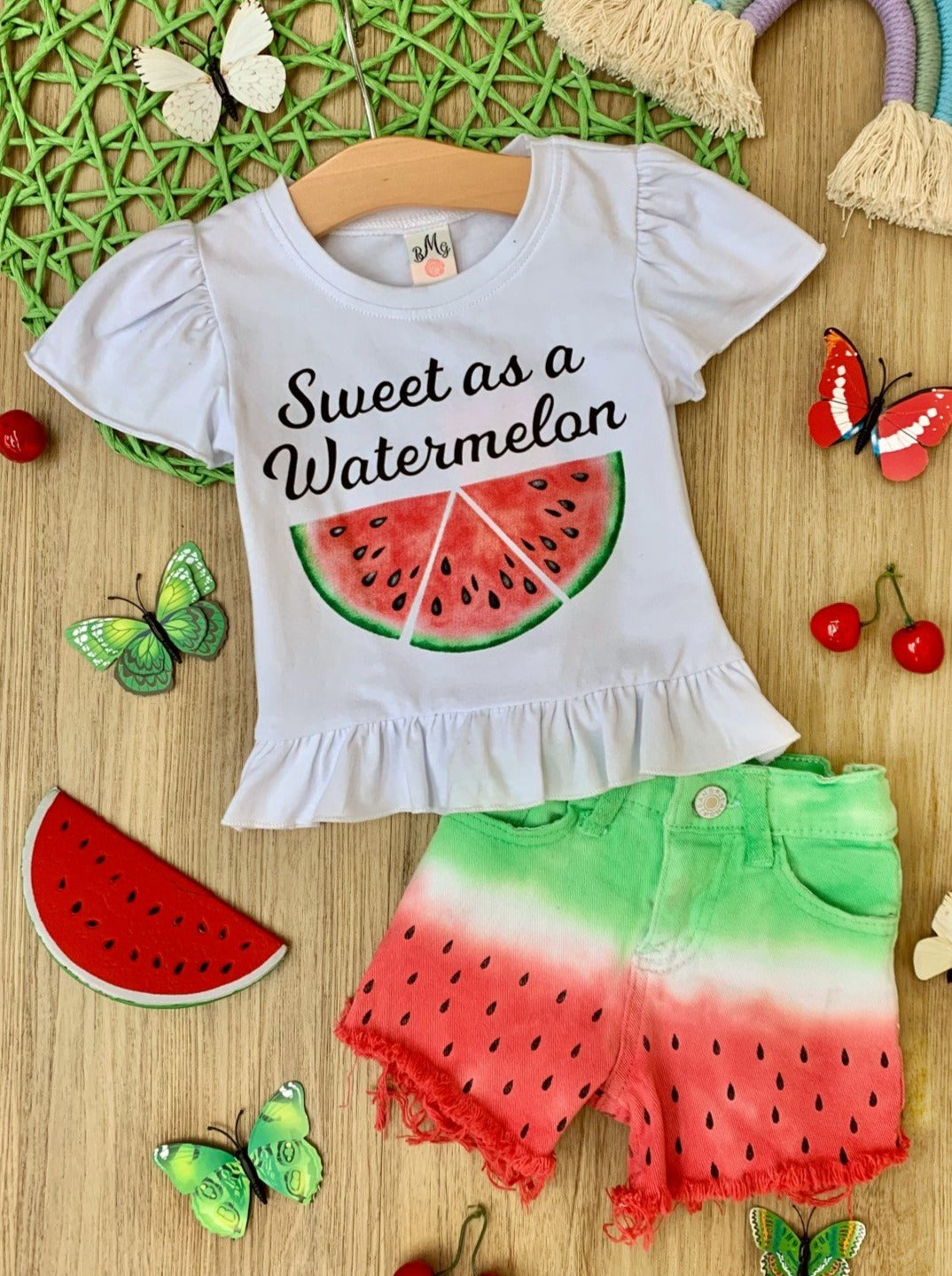 Girls set features a white ruffled top with "Sweet as a Watermelon" and tie-dye watermelon denim shorts
