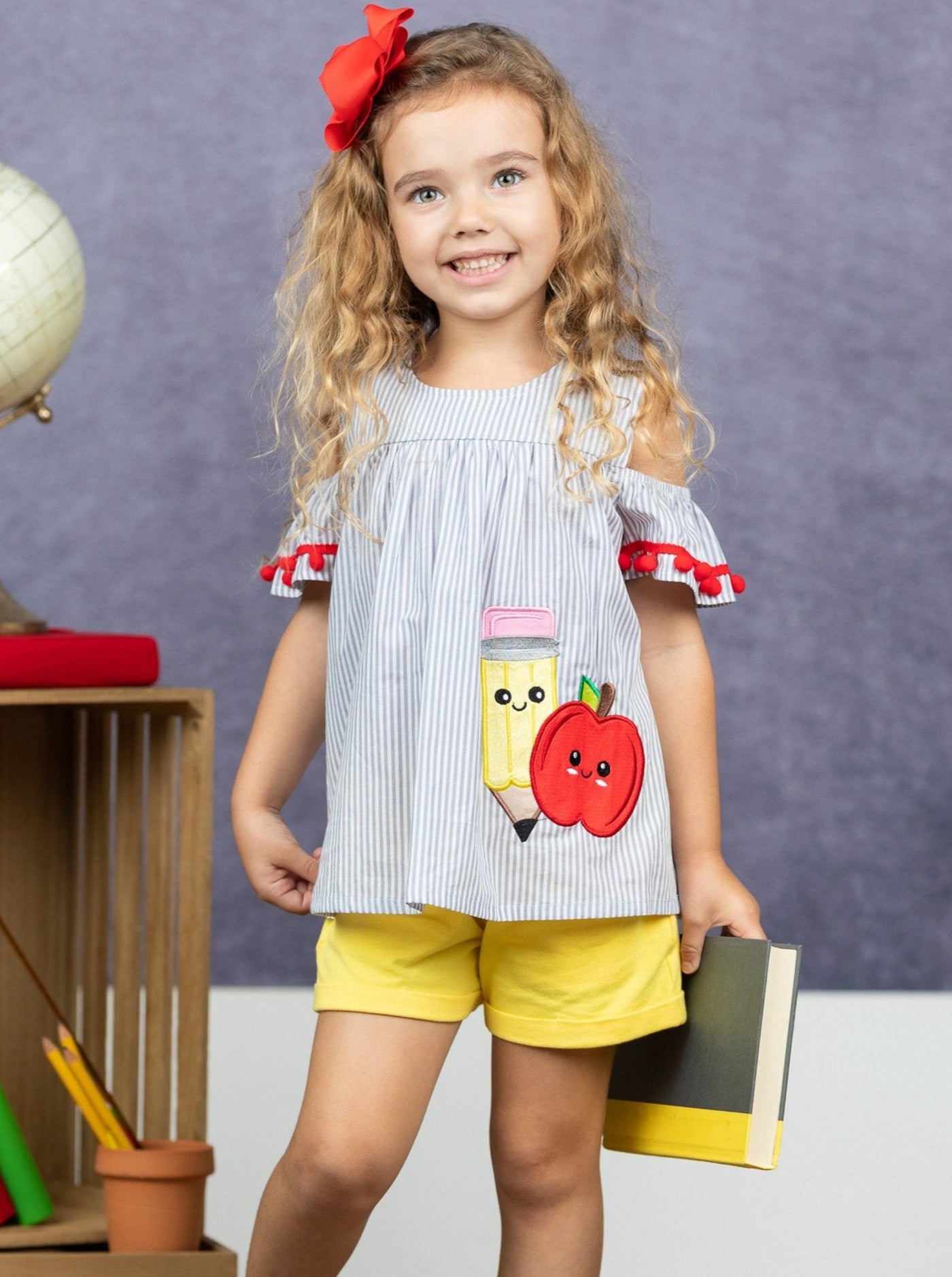 Girls set features a top with apple applique with pompom details with shorts and pompom details