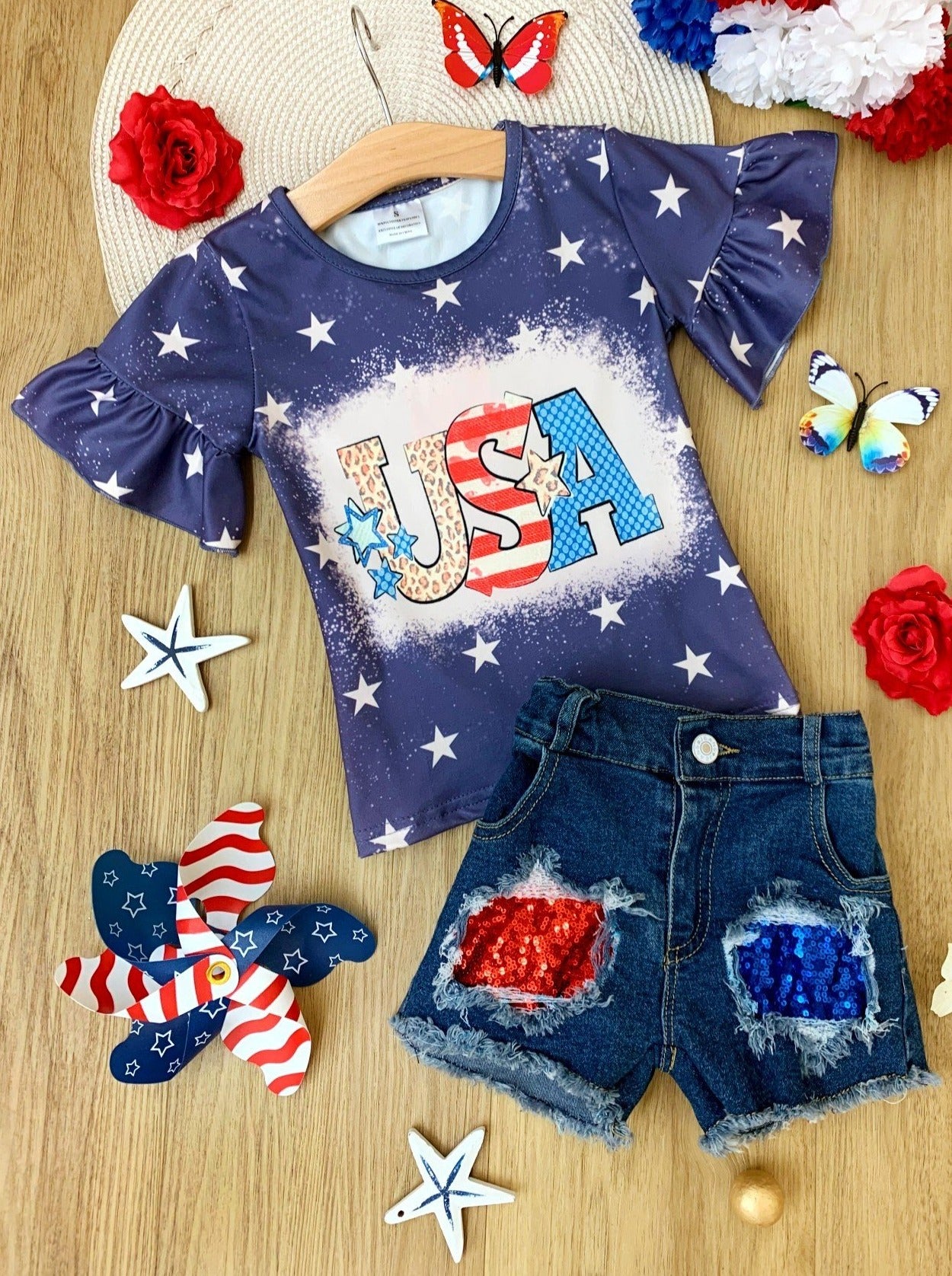 Girls set features a starred top with USA print and red/blue sequin patched denim shorts