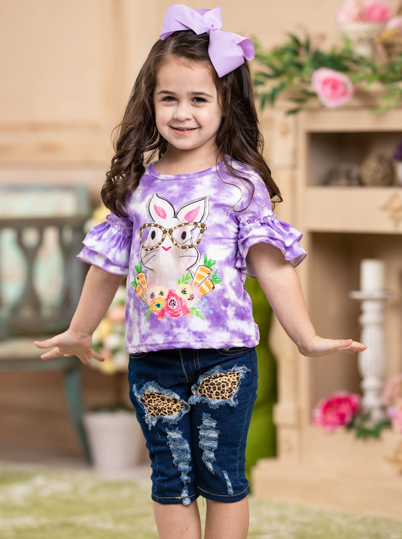 Girls Easter-themed set features a purple tie-dye top with bunny graphic and leopard print patched jeans with sash for 2T to 10Y toddlers and girls
