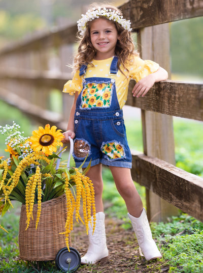 Girls Summer set features a yellow ruffle sleeve top with white polka dots and denim overall shorts with sunflower print and sequin mesh patches - 2T-10Y