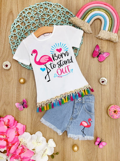 Girls Summer set features a "Born to Stand Out" and flamingo graphic top adorned with multicolor tassels on the hem and matching frayed denim shorts with a flamingo applique