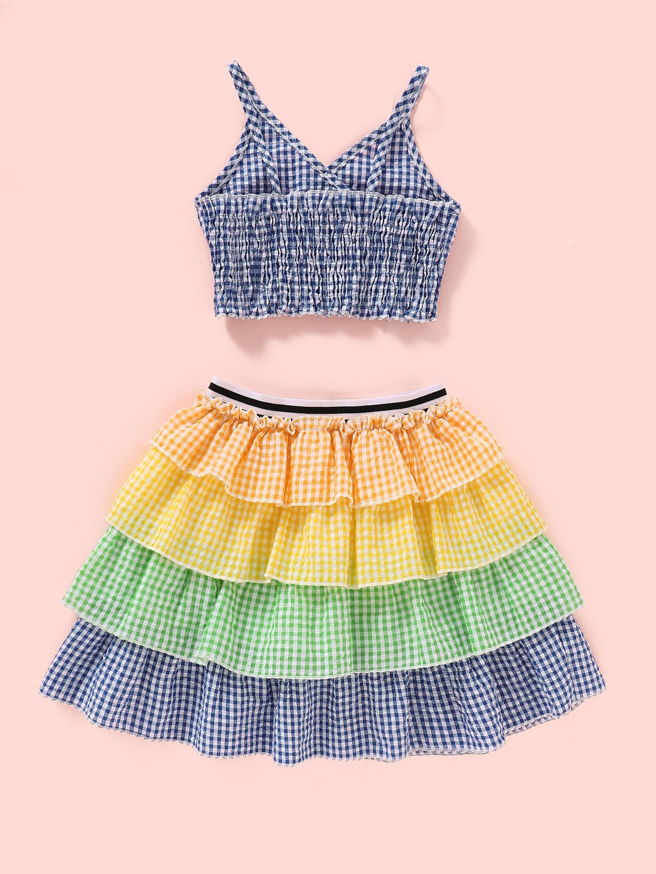 Girls set features a plaid cropped top and multi-layered skirt