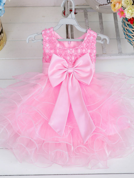 Baby princess dress has a satin bodice with pearl details, a bow belt at the waist, and a layered tulle skirt -pink