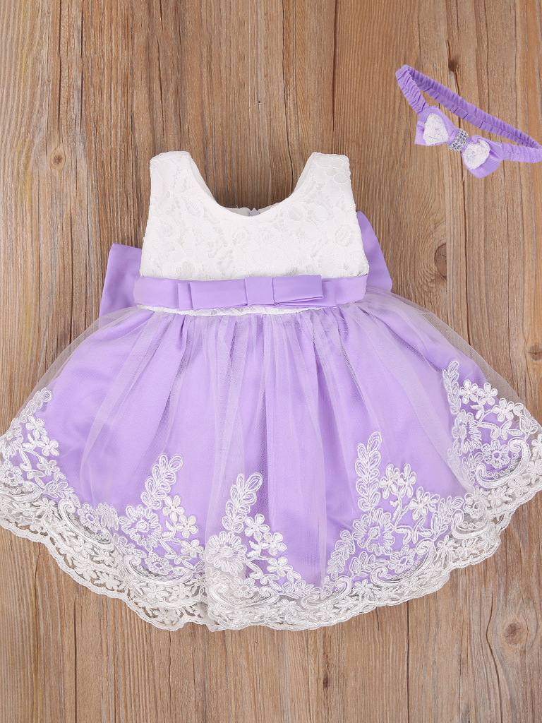 Girls Spring dress has a short-sleeved lace bodice and a skirt with lace hem and a big bow on the back, comes with a matching headband