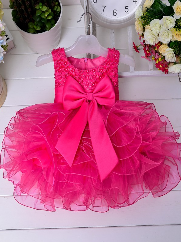 Baby princess dress has a satin bodice with pearl details, a bow belt at the waist, and a layered tulle skirt -hot pink
