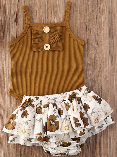 Baby onesie bodysuit has a cute ruffle detail and front buttons and spaghetti straps and skirted bloomers