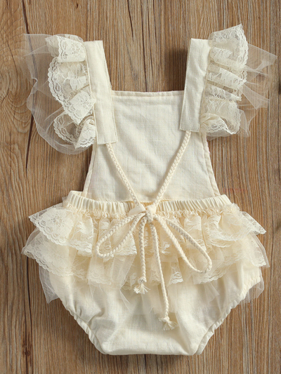 Baby overall style onesie with delicate flower embroidered, lace ruffles on the bum that ties in the back, tulle, and lace ruffled shoulders