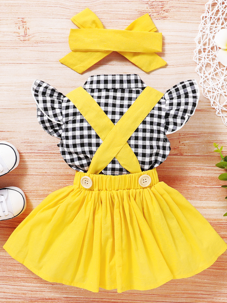 Baby set features a plaid top with front buttons and bow at the color, a skirt with cute suspenders, and a matching headband