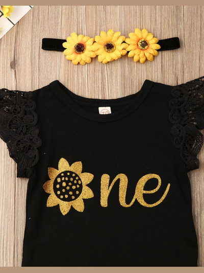 Baby set has a onesie with ruffled lace sleeves and "One" printed, a tutu skirt with sunflower sash, and a matching sunflower headband