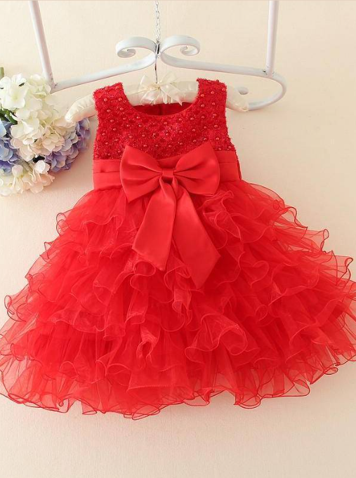 Baby tulle dress bodice has a delicate pearl detail with a bow at the waistline and a multilayer tulle skirt