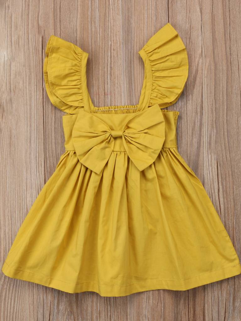 Baby apron style dress has a ruffled adjustable straps and a stretchy bodice with a big bow