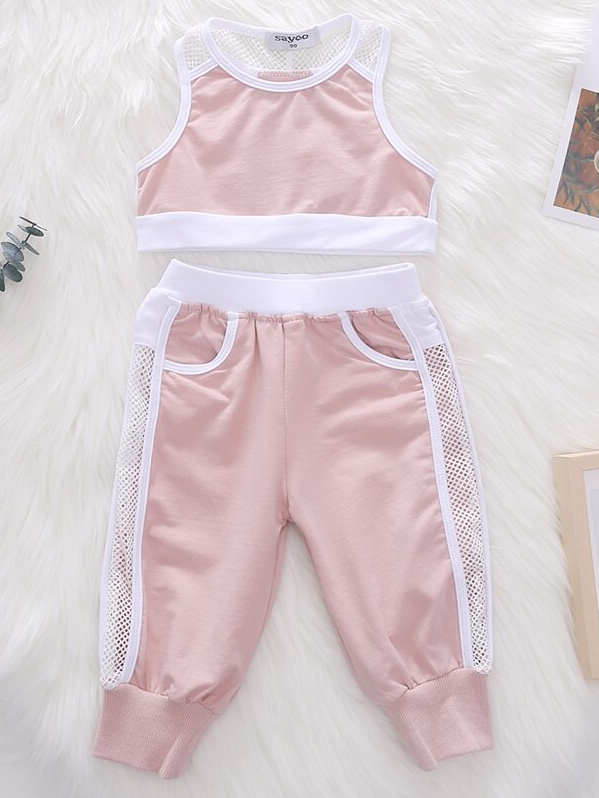 Girls set features a pink cropped top and pants with pocket and mesh details