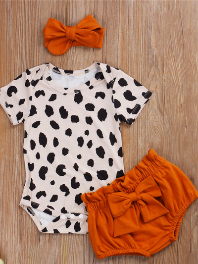 Baby set features a short-sleeved onesie with animal print, bloomer shorts with a bow, and matching headbands