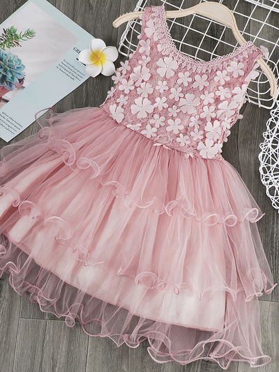Girls tulle dress features a bodice with flower applique and multi-layered skirt, delicate bow details on the back