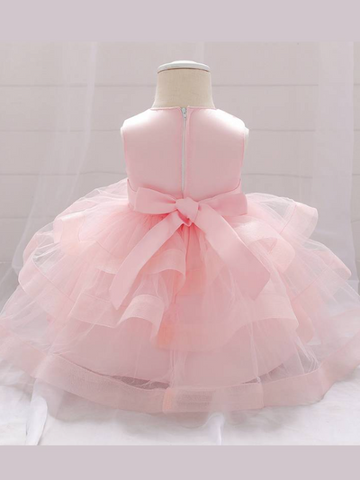 Baby princess dress has a satin bodice with sequin applique, a bow belt at the waist, and a layered tulle skirt