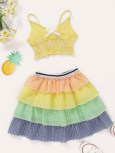 Girls set features a plaid cropped top and multi-layered skirt