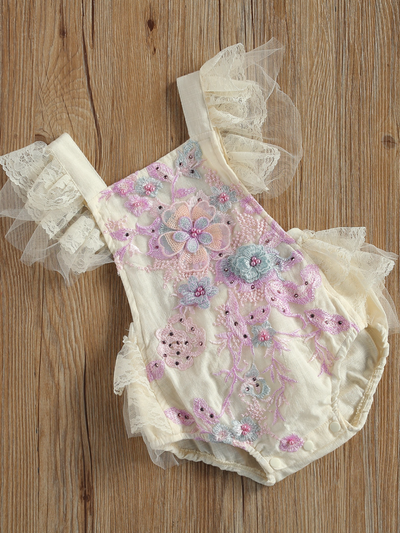 Baby overall style onesie with delicate flower embroidered, lace ruffles on the bum that ties in the back, tulle, and lace ruffled shoulders 