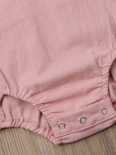 Baby onesie has cute little shoulder ruffles and ruffles on the side. Overall style with strap closure at the back 